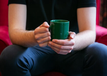 Man sitting down holding a coffee mug