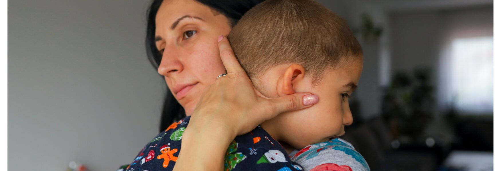 mother holding onto her son in her arms
