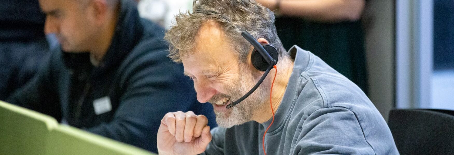 a Man smiling and wearing a headset