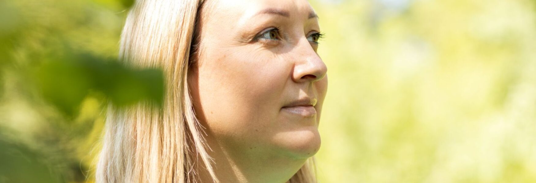Close up outdoor portrait of attractive 40 year old blonde woman